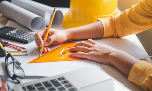 engineer-working-office-with-blueprints